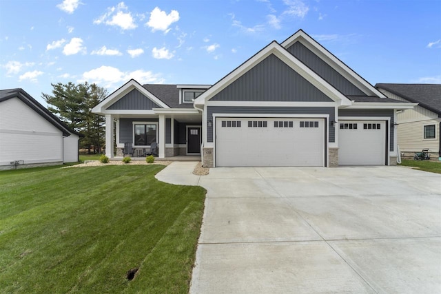 1205 Thistle Dew Ln, Waunakee, WI 53597 - craftsman-style home with board and batten siding, an attached garage, stone siding, a front lawn, and driveway