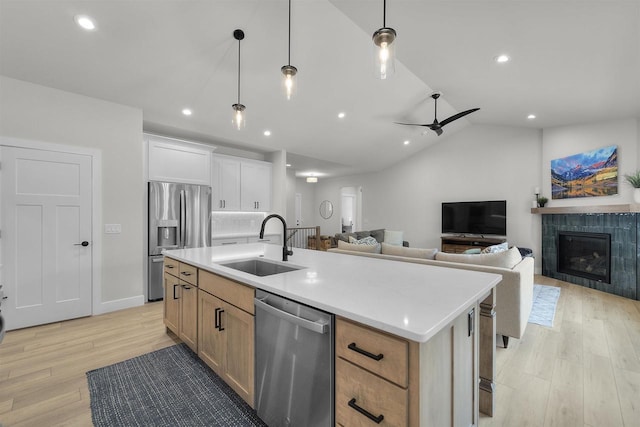1205 Thistle Dew Ln, Waunakee, WI 53597 - kitchen featuring appliances with stainless steel finishes, a sink, light wood finished floors, a kitchen island with sink, and open floor plan