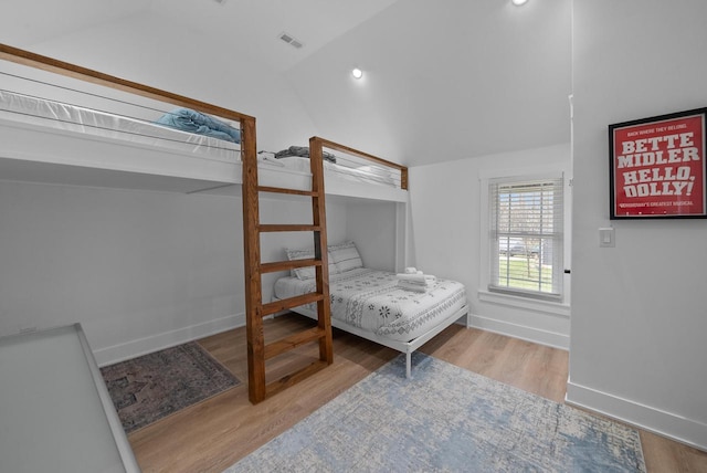 397 W Geneva St, Williams Bay, WI 53191 - bedroom with baseboards, vaulted ceiling, wood finished floors, and visible vents