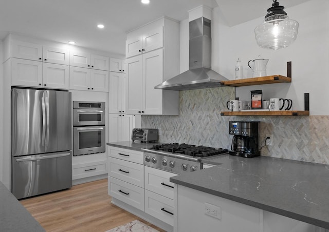 397 W Geneva St, Williams Bay, WI 53191 - kitchen featuring decorative backsplash, wall chimney exhaust hood, white cabinetry, and stainless steel appliances