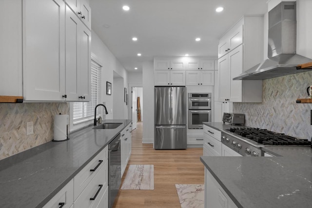 397 W Geneva St, Williams Bay, WI 53191 - kitchen with a sink, dark stone counters, stainless steel appliances, recessed lighting, and wall chimney exhaust hood