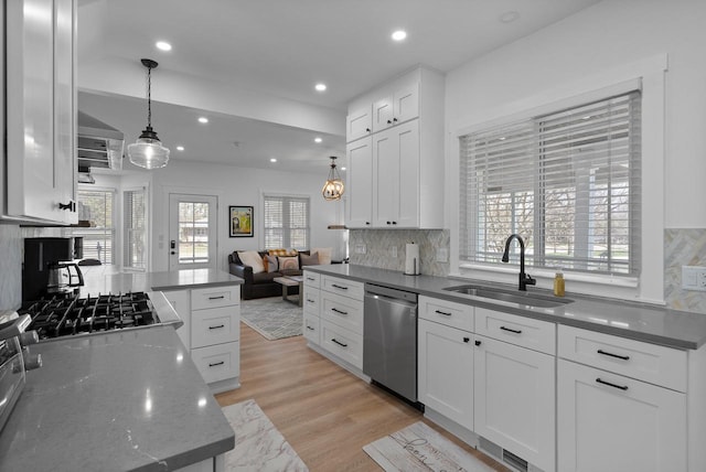 397 W Geneva St, Williams Bay, WI 53191 - kitchen featuring a sink, tasteful backsplash, stainless steel dishwasher, and a healthy amount of sunlight