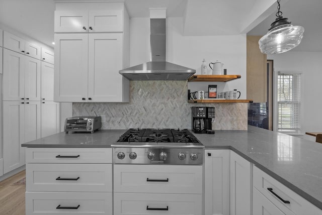 397 W Geneva St, Williams Bay, WI 53191 - kitchen with decorative backsplash, wall chimney exhaust hood, white cabinets, and stainless steel gas stovetop
