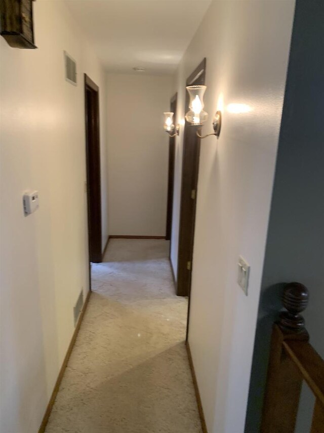 312 W Buehler Ave, Nekoosa, WI 54457 - hallway featuring light colored carpet, baseboards, and visible vents