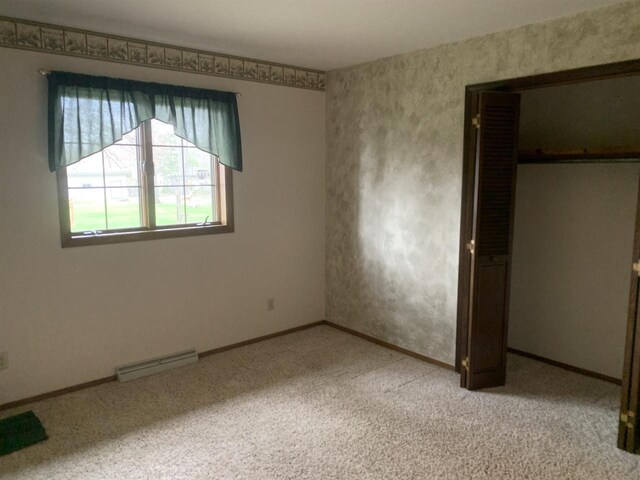 312 W Buehler Ave, Nekoosa, WI 54457 - unfurnished bedroom with a closet, baseboards, light colored carpet, and visible vents