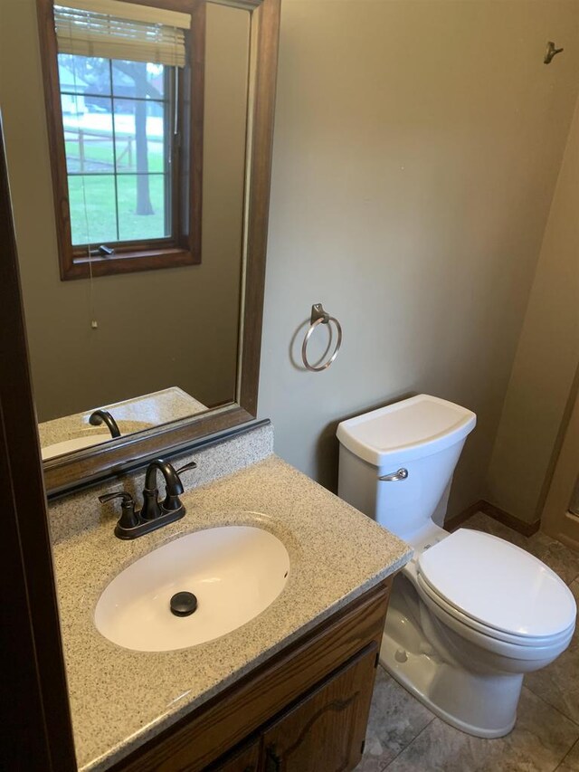 312 W Buehler Ave, Nekoosa, WI 54457 - bathroom featuring vanity, tile patterned floors, and toilet