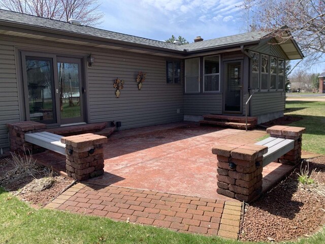 312 W Buehler Ave, Nekoosa, WI 54457 - rear view of property featuring a shingled roof, a patio area, and entry steps
