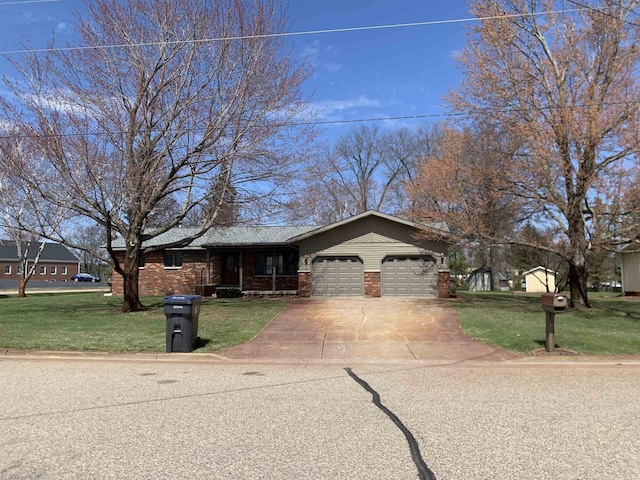 312 W Buehler Ave, Nekoosa, WI 54457 - ranch-style home featuring an attached garage, driveway, a front lawn, and brick siding