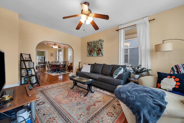 1932 N Warren Ave Unit 1934, Milwaukee, WI 53202 - living area featuring arched walkways, ceiling fan, and wood finished floors