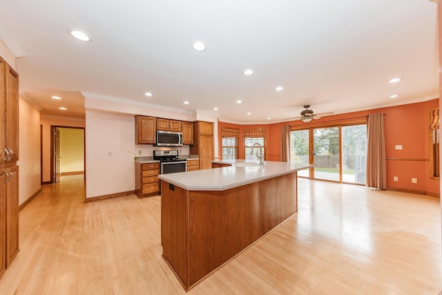 kitchen with brown cabinetry, light countertops, ornamental molding, stainless steel appliances, and recessed lighting