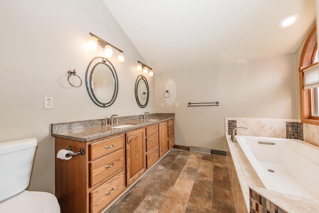 full bath featuring double vanity, a relaxing tiled tub, a sink, baseboards, and toilet