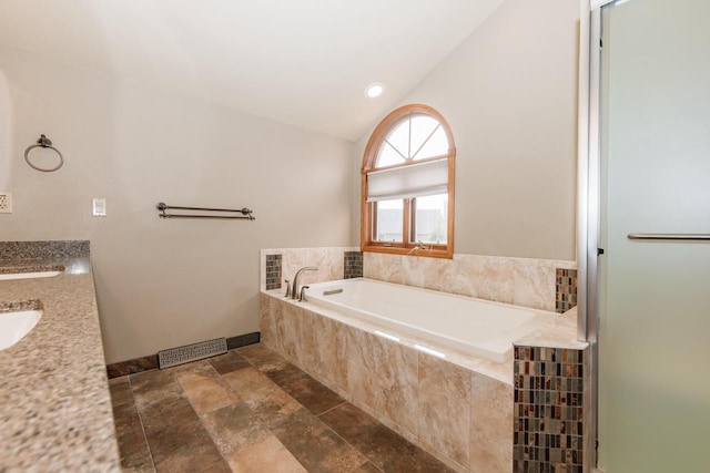 full bathroom with visible vents, baseboards, stone finish flooring, vaulted ceiling, and a bath