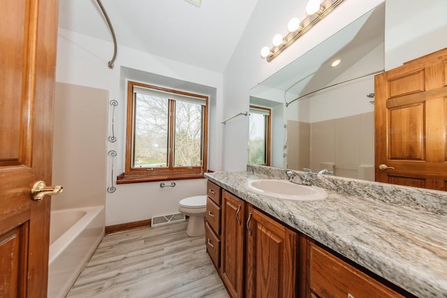full bath with visible vents, wood finished floors, vanity, toilet, and lofted ceiling