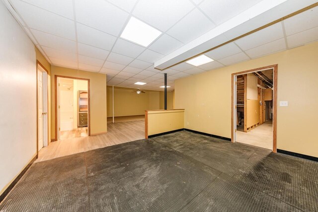 finished below grade area featuring baseboards and carpet