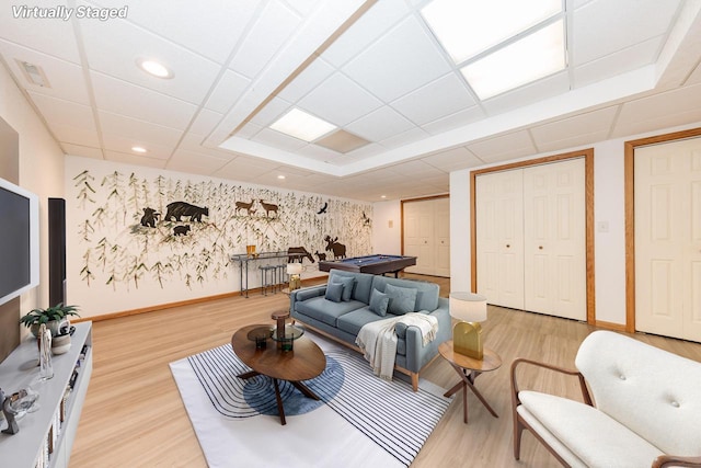 living area with recessed lighting, baseboards, and light wood-style flooring
