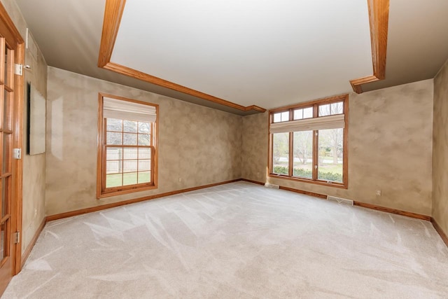 unfurnished room featuring light colored carpet, baseboards, and visible vents