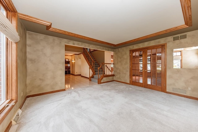 unfurnished living room featuring french doors, baseboards, visible vents, and stairway
