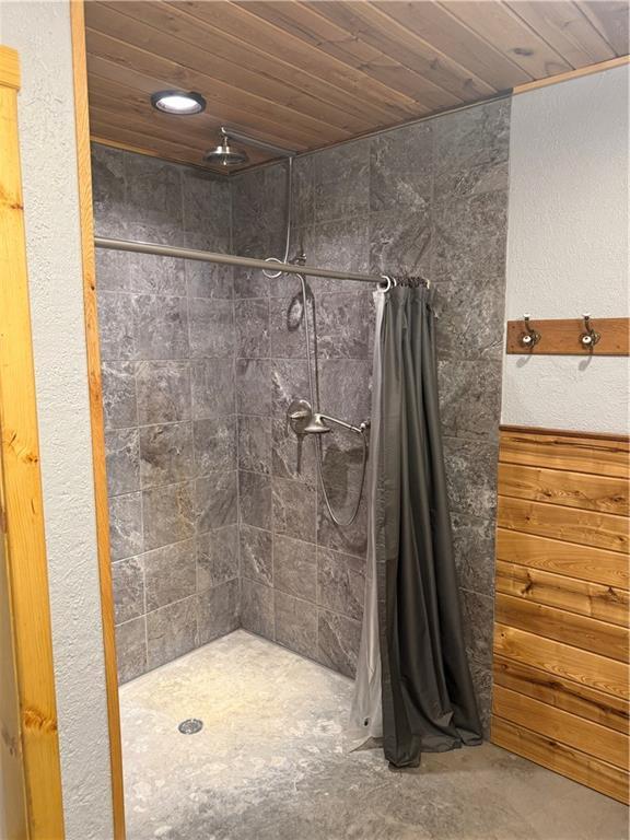 8523 Lakeside Rd, Trego, WI 54888 - full bathroom with a tile shower and wooden ceiling