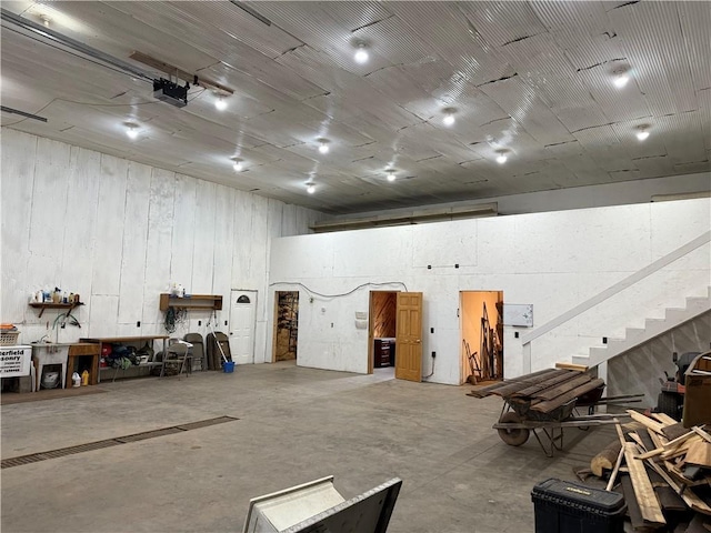 8523 Lakeside Rd, Trego, WI 54888 - misc room featuring stairs, concrete floors, and a high ceiling