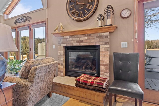 E2145 Johanson Rd, Iola, WI 54945 - living area with wood finished floors, a healthy amount of sunlight, and a fireplace