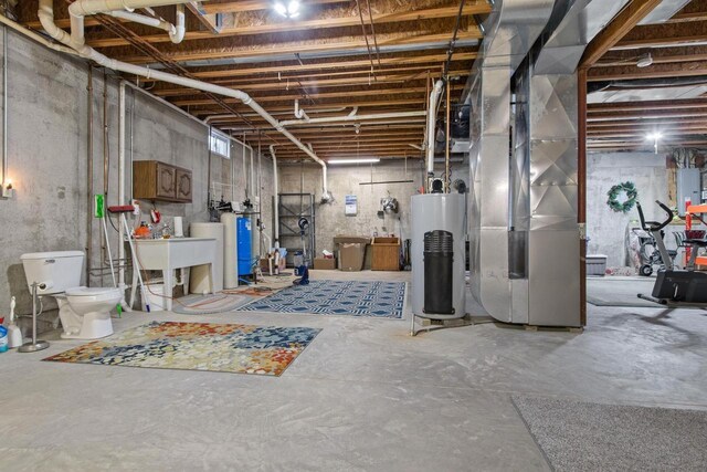 E2145 Johanson Rd, Iola, WI 54945 - unfinished basement featuring water heater and a sink