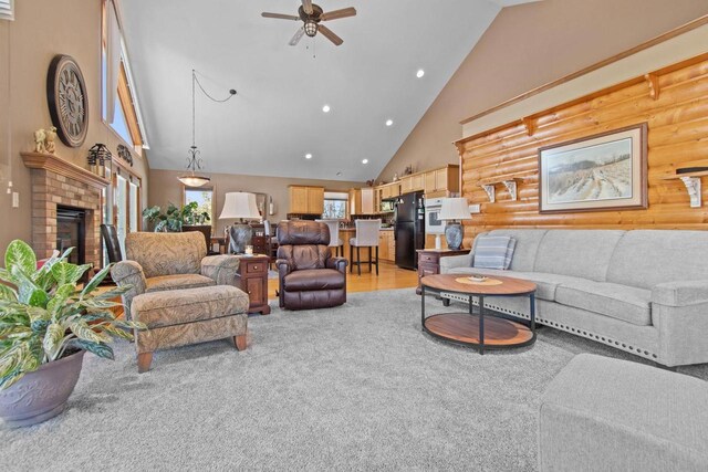 E2145 Johanson Rd, Iola, WI 54945 - living room with ceiling fan, light colored carpet, high vaulted ceiling, log walls, and recessed lighting