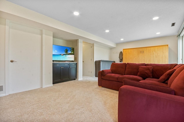 living room featuring recessed lighting, visible vents, and light carpet