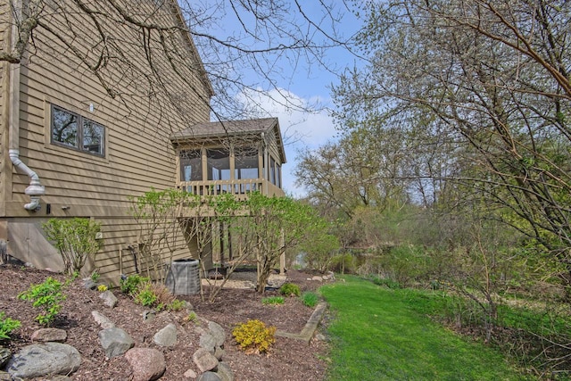 view of yard featuring a sunroom and cooling unit