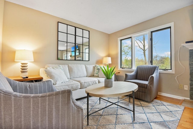 living room featuring baseboards and wood finished floors