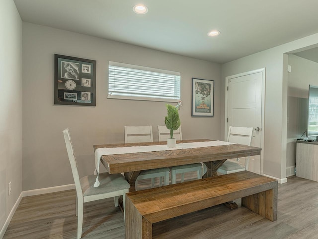 dining space featuring recessed lighting, baseboards, light wood finished floors, and a wealth of natural light