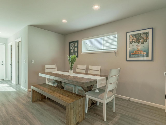 dining area featuring baseboards, recessed lighting, and wood finished floors