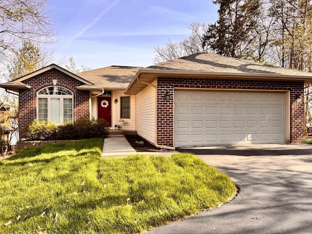 ranch-style house with roof with shingles, driveway, a front lawn, and brick siding