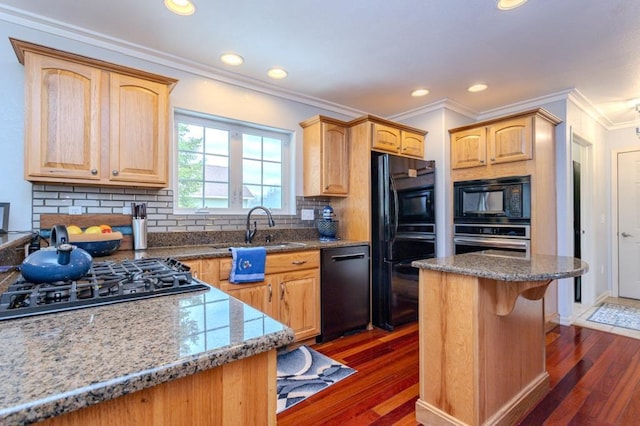 kitchen featuring crown molding, dark wood-style flooring, a sink, and black appliances