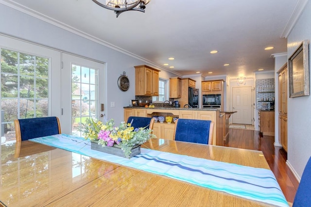 dining space featuring crown molding, recessed lighting, dark wood-style flooring, and a wealth of natural light