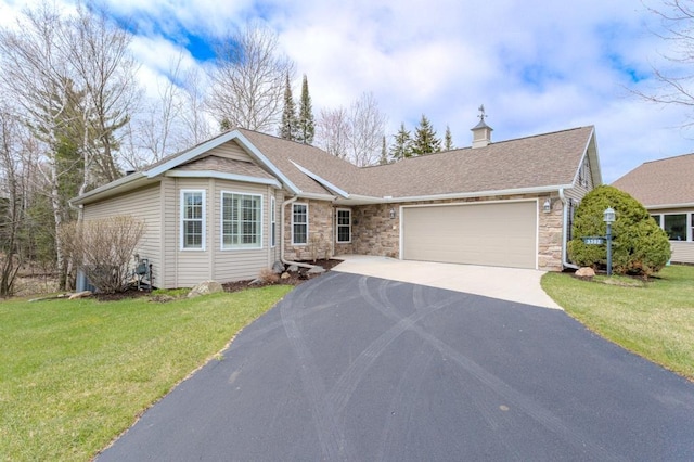 single story home featuring stone siding, a front yard, a shingled roof, an attached garage, and driveway