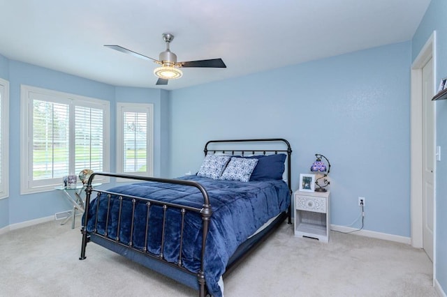 carpeted bedroom with a ceiling fan and baseboards