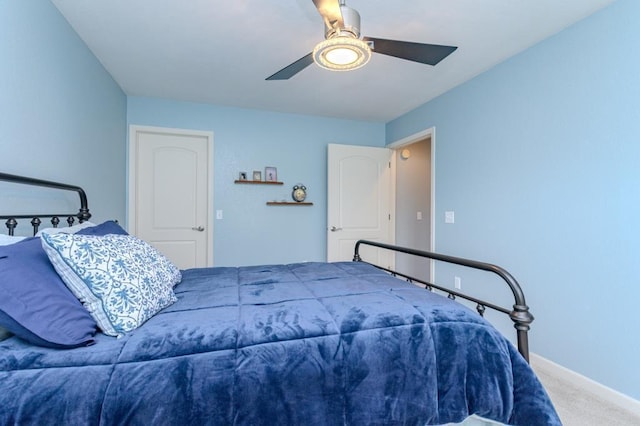 carpeted bedroom with baseboards and ceiling fan
