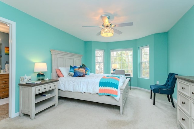 bedroom with baseboards, ceiling fan, and light carpet