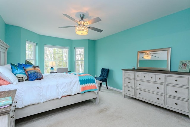 bedroom featuring baseboards, a ceiling fan, and light carpet