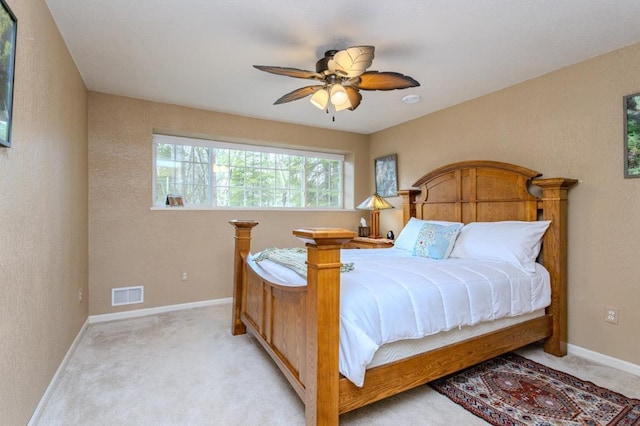 bedroom featuring baseboards, light carpet, and visible vents