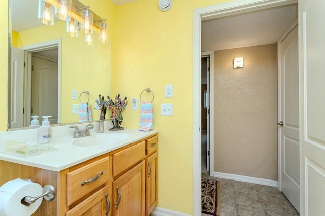 bathroom with vanity and baseboards