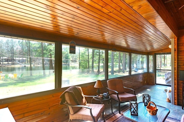 sunroom with wood ceiling, vaulted ceiling, and wooden walls