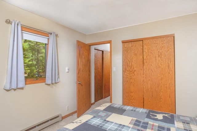 unfurnished bedroom featuring baseboards, a baseboard heating unit, and a closet