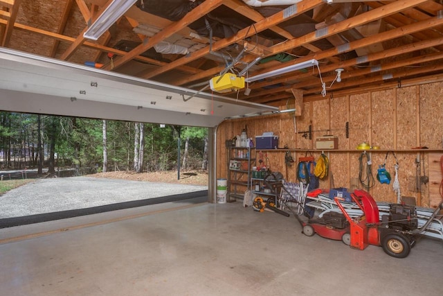 garage with wooden walls and a garage door opener