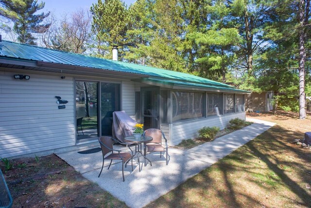 view of patio with a sunroom