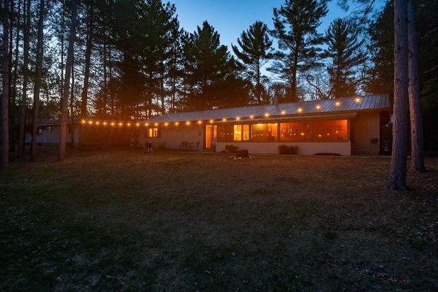 back of house featuring metal roof