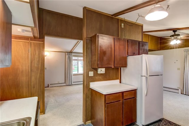 kitchen with freestanding refrigerator, ceiling fan, light colored carpet, and baseboard heating