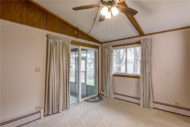 empty room featuring vaulted ceiling, a healthy amount of sunlight, carpet, and a baseboard radiator