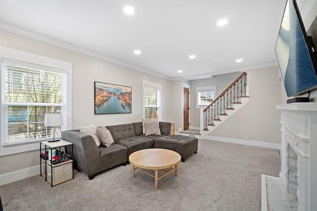 carpeted living room featuring a fireplace with flush hearth, stairs, baseboards, ornamental molding, and recessed lighting