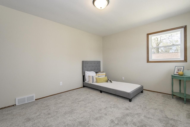 bedroom featuring baseboards, light colored carpet, and visible vents